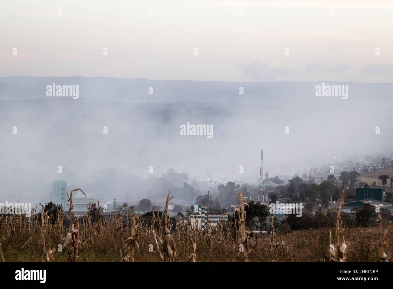 A residential area covered with smoke from a nearby Gioto garbage dump