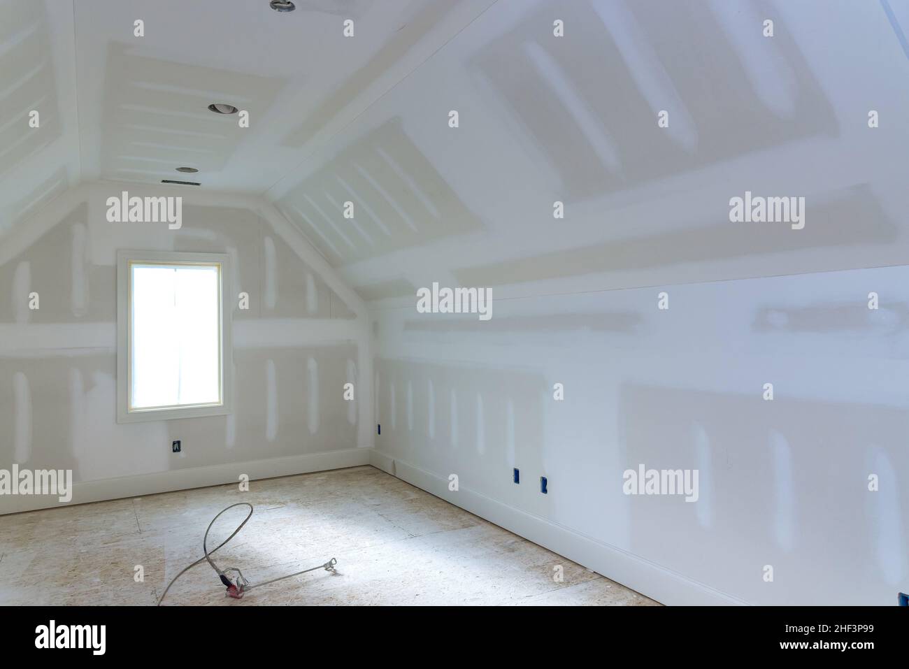 Finishing plastering drywall in ready for paint with new house Stock Photo Alamy