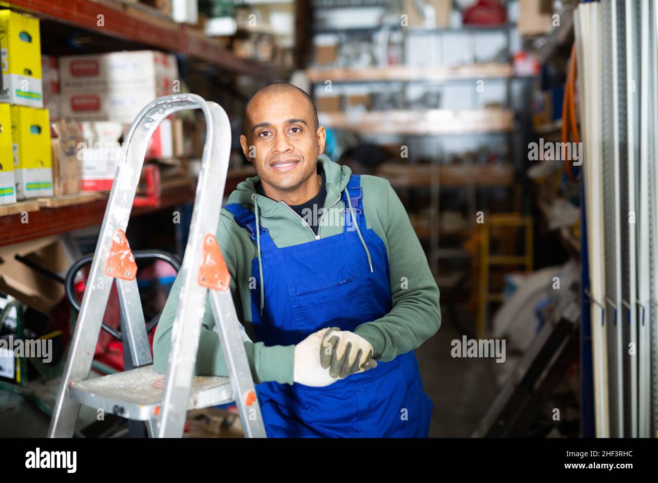 Hispanic Rack Hispanic worker of building materials warehouse near racks with goods ...