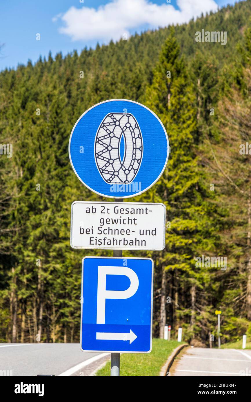 snow chain sign with parking place to change in the alps Stock Photo Alamy