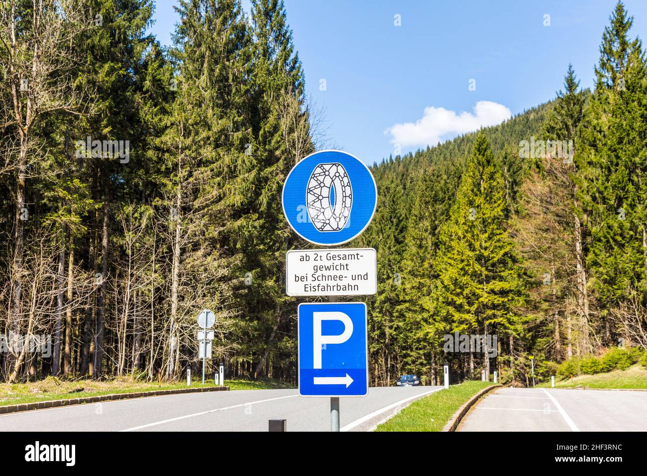 snow chain sign with parking place to change in the alps Stock Photo