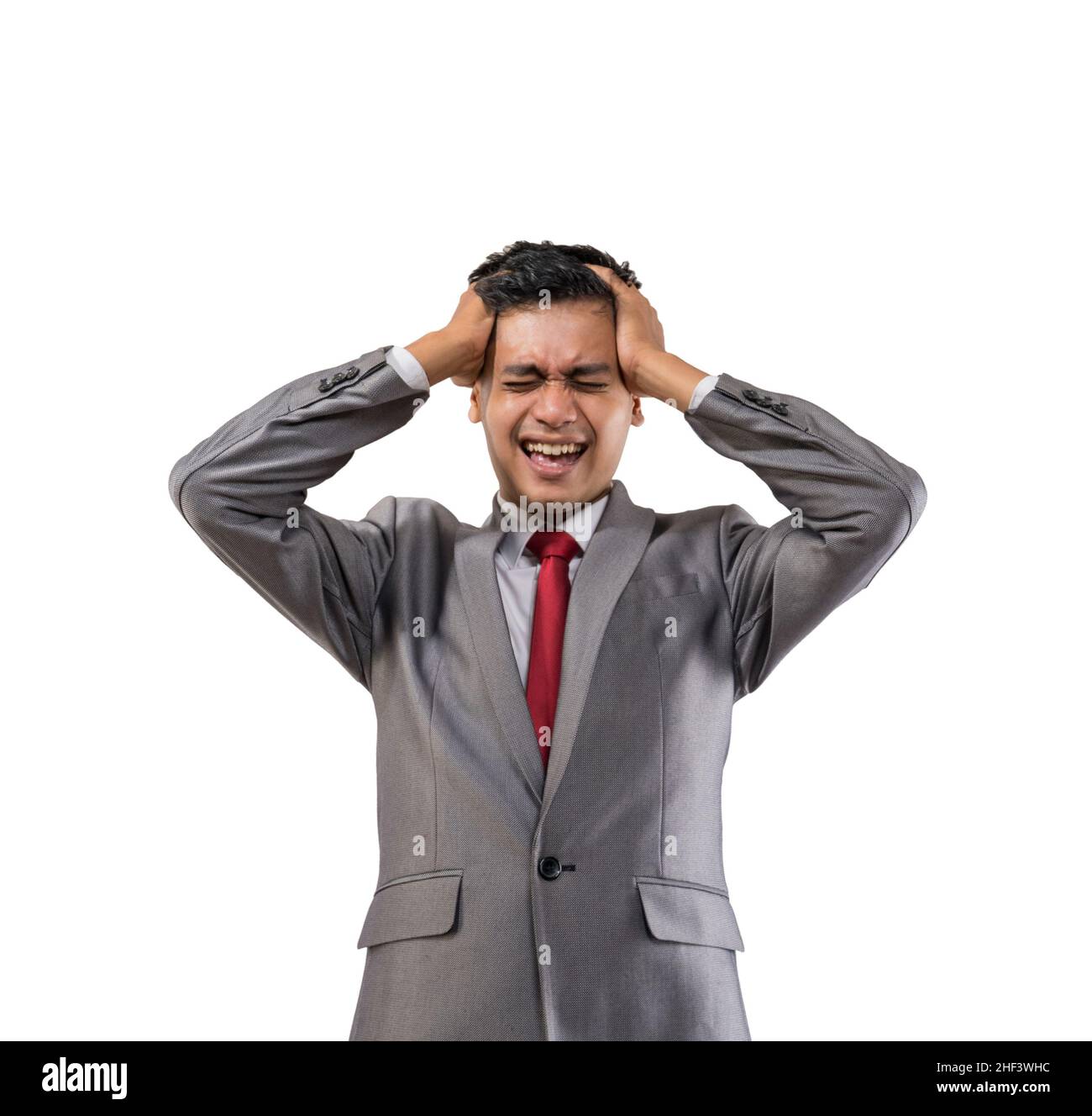 stressed young businessman holding his head isolated Stock Photo - Alamy
