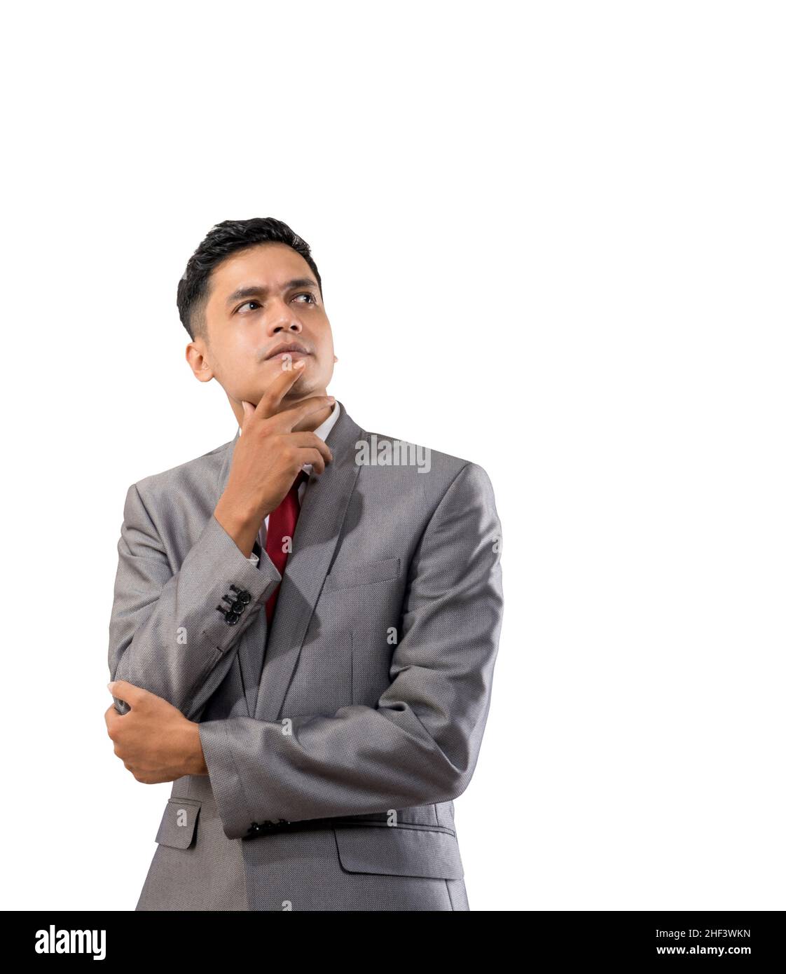 businessman thinking while looking up to copyspace Stock Photo