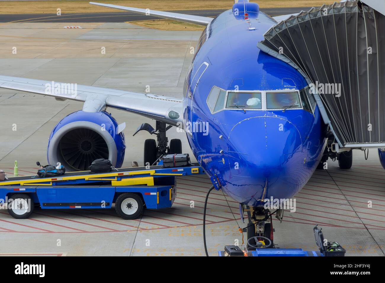 Downloading baggage on the conveyor belt to the airplane Stock Photo Alamy