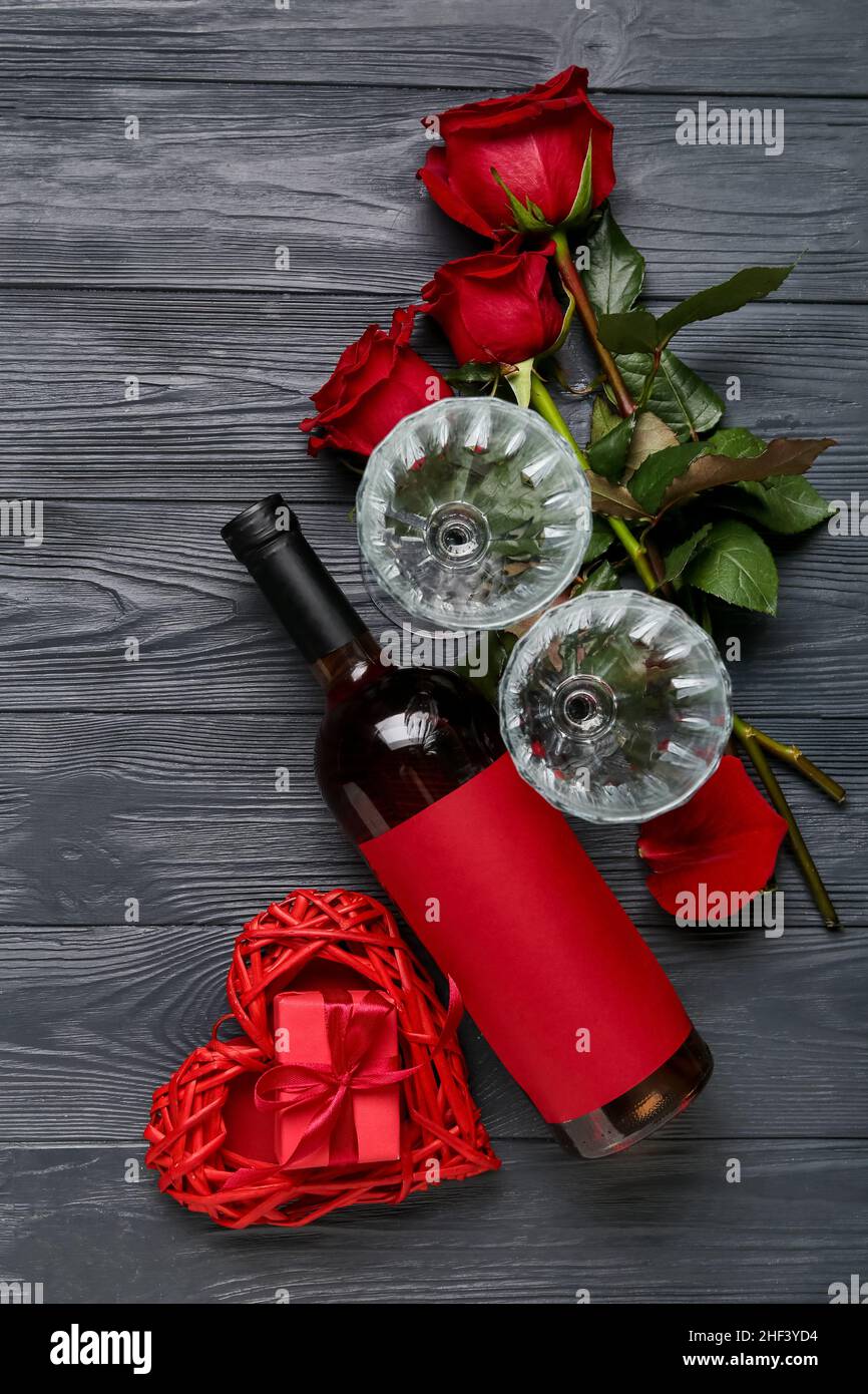 Composition with bottle of wine, glasses and roses for Valentine's Day ...