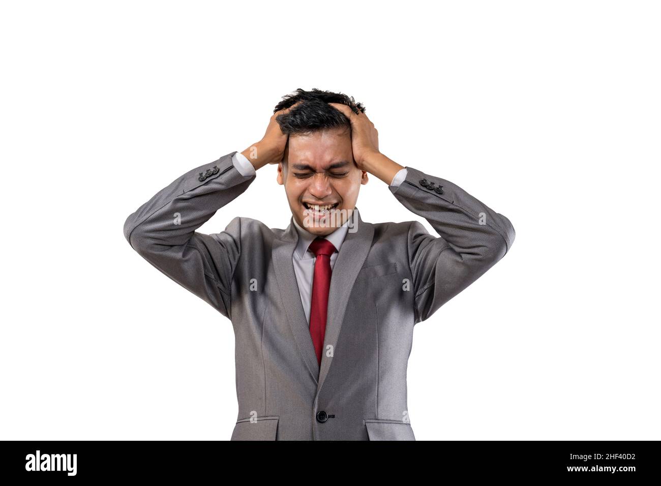 stressed young businessman holding his head isolated Stock Photo - Alamy