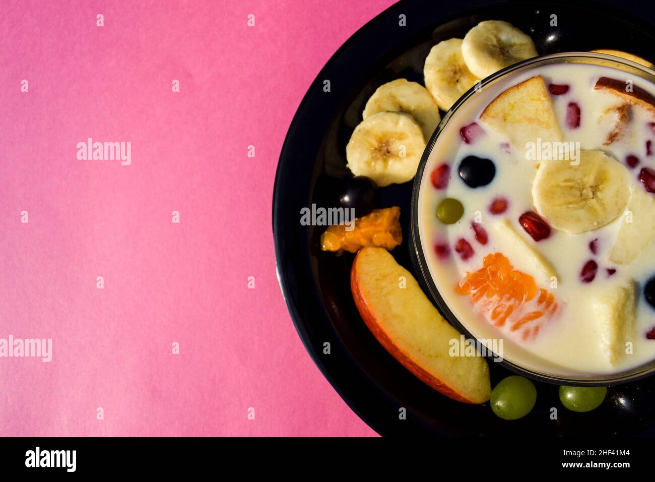 A bowl of creamy Custard based fruit salad dessert popular recipe Stock Photo