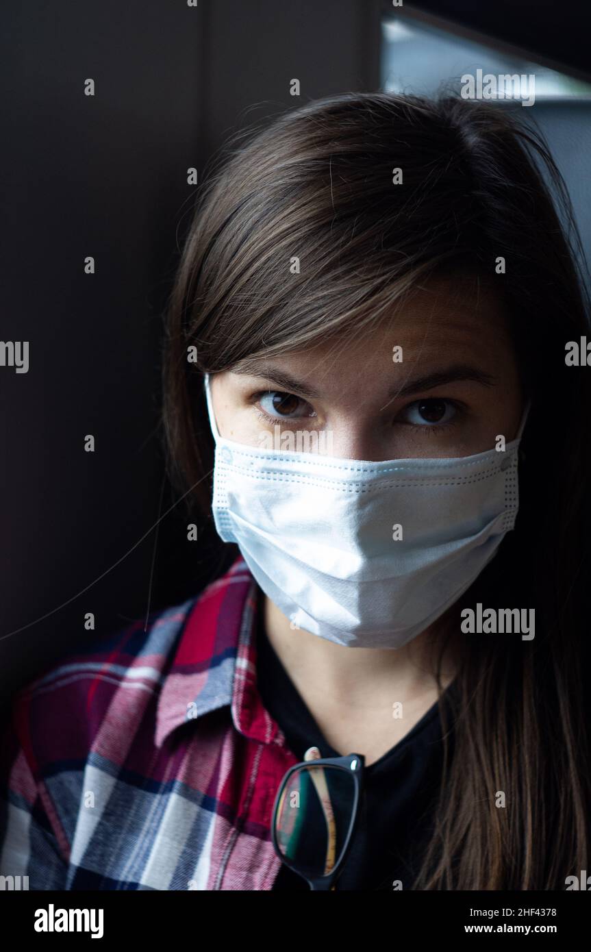 Portrait of a beautiful young woman in a medical mask. Travel in ...