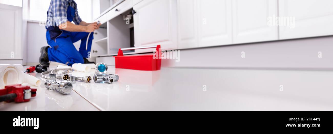 Plumber Cleaning Kitchen Drain And Pipe Using Tools Stock Photo Alamy