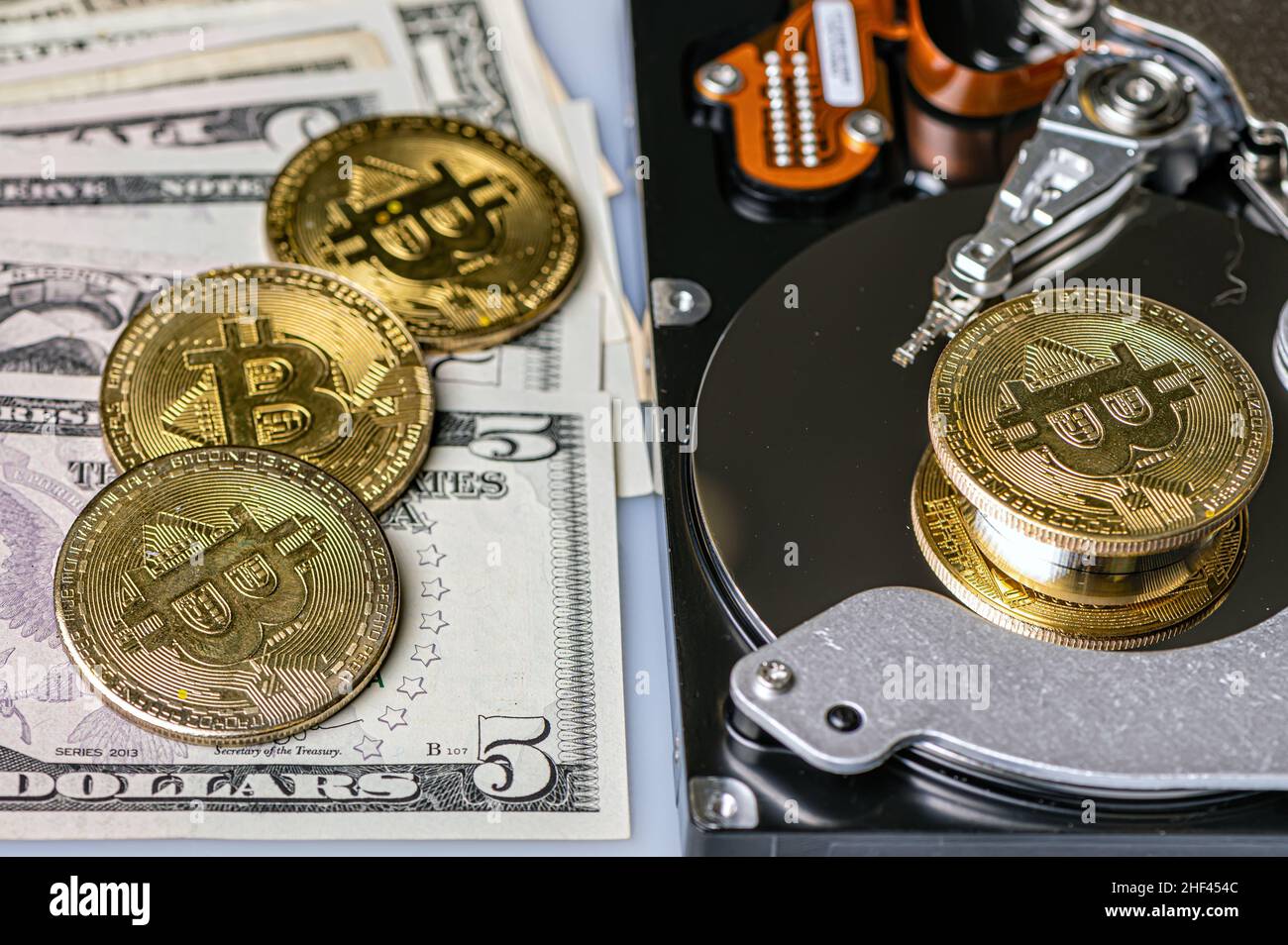 Bitcoin BTC coins, open hard drive and dollar bills, cryptocurrency and ...