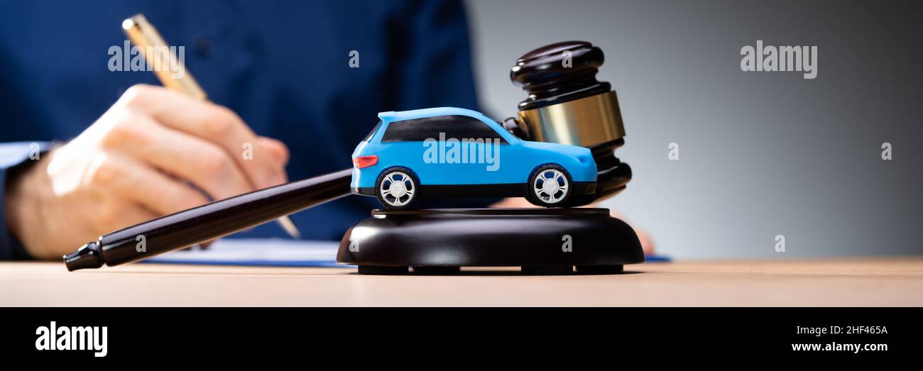Small Blue Car In Front Of Judge Mallet Stock Photo