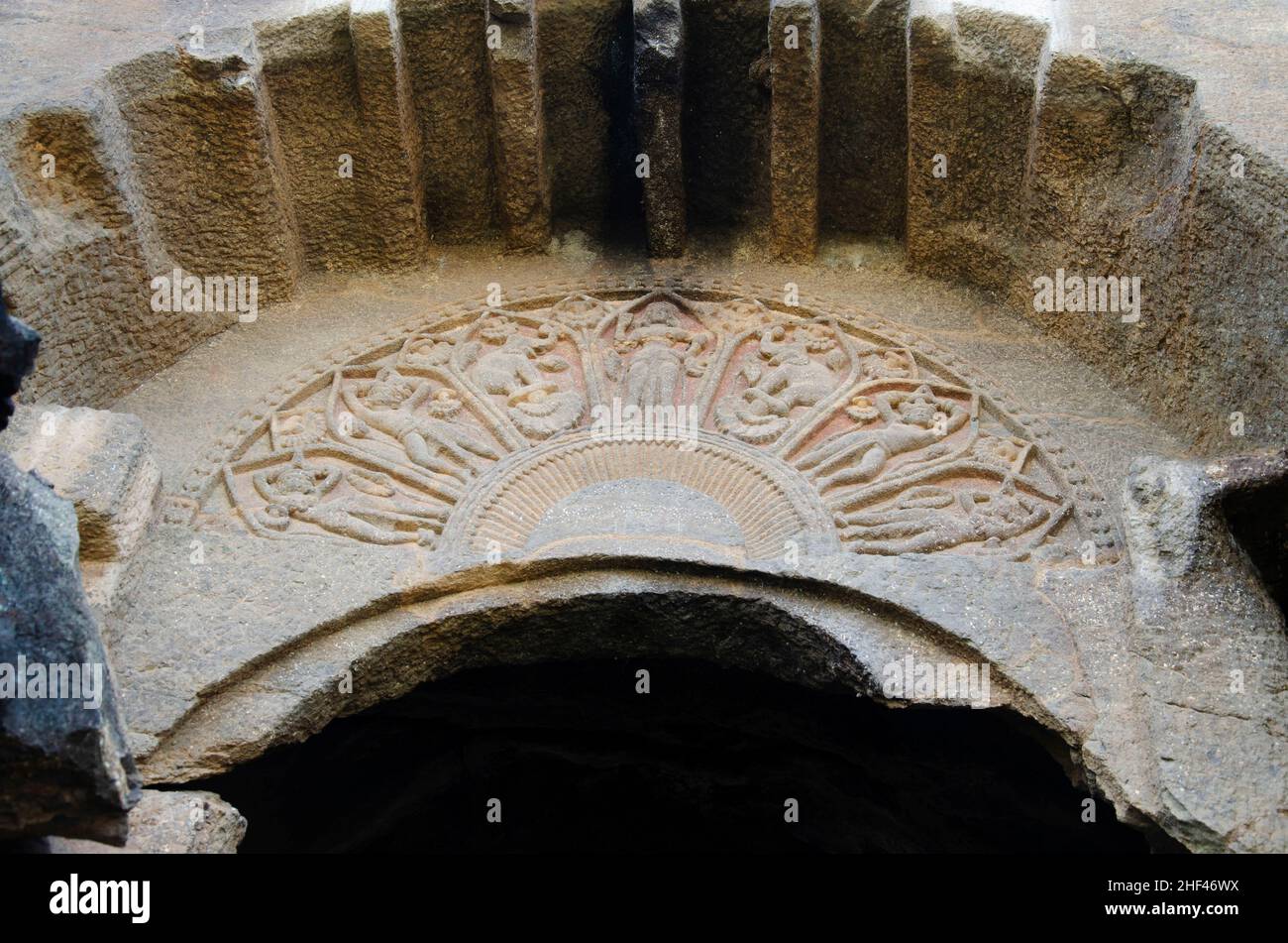 Bhutalinga cave with a horseshoe arch over the entrance containing petal-shaped compartments filled with reliefs of Lakshmi, elephants and devotees Stock Photo