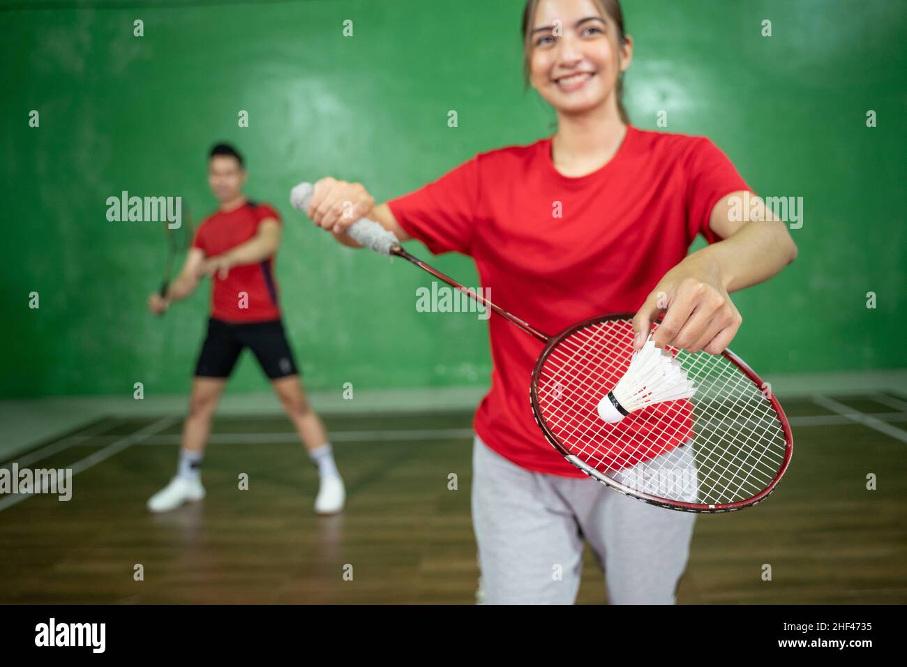 A shuttlecock is held by a female badminton player Stock Photo - Alamy