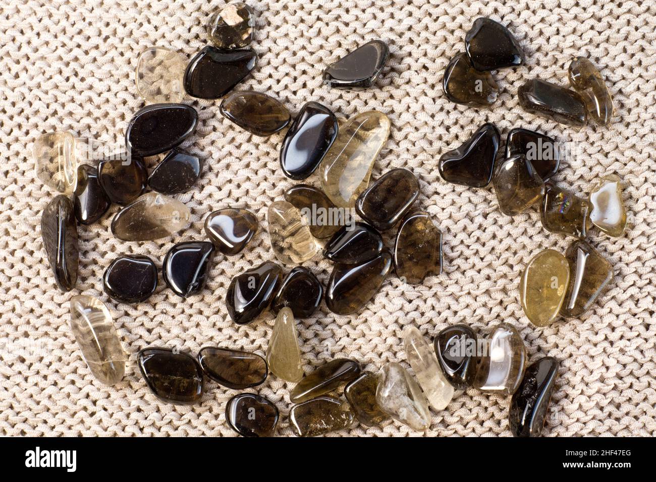 Macro shooting of collection natural rock set of morion, smoky quartz crystals gem mineral stones on grey background top view Stock Photo