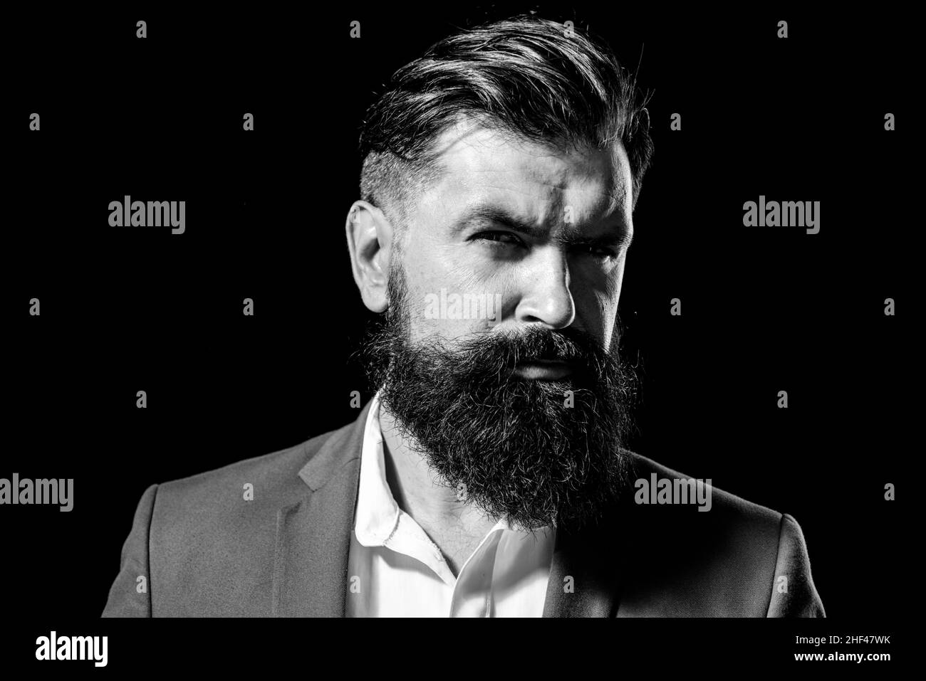 Man haircut, modern hair style. Close up portrait of male model with long hair. Healthcare and