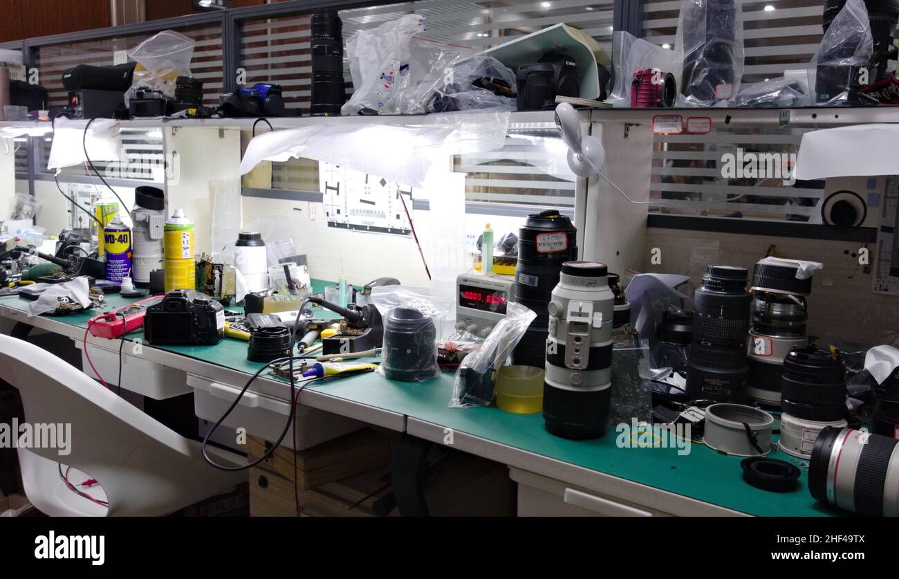 Camera and lens repair workstation with equipment and tools Stock Photo