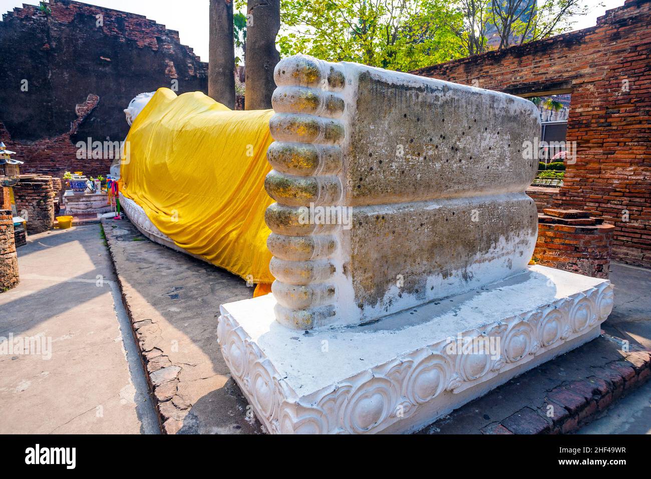 lying Buddha dressed in yellow scarf in temple Wat Yai Chai-mongkol Stock Photo