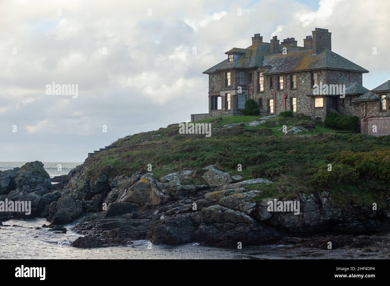 Large grey house overlooking the sea at Trearddur Bay, Anglesey, Wales Stock Photo