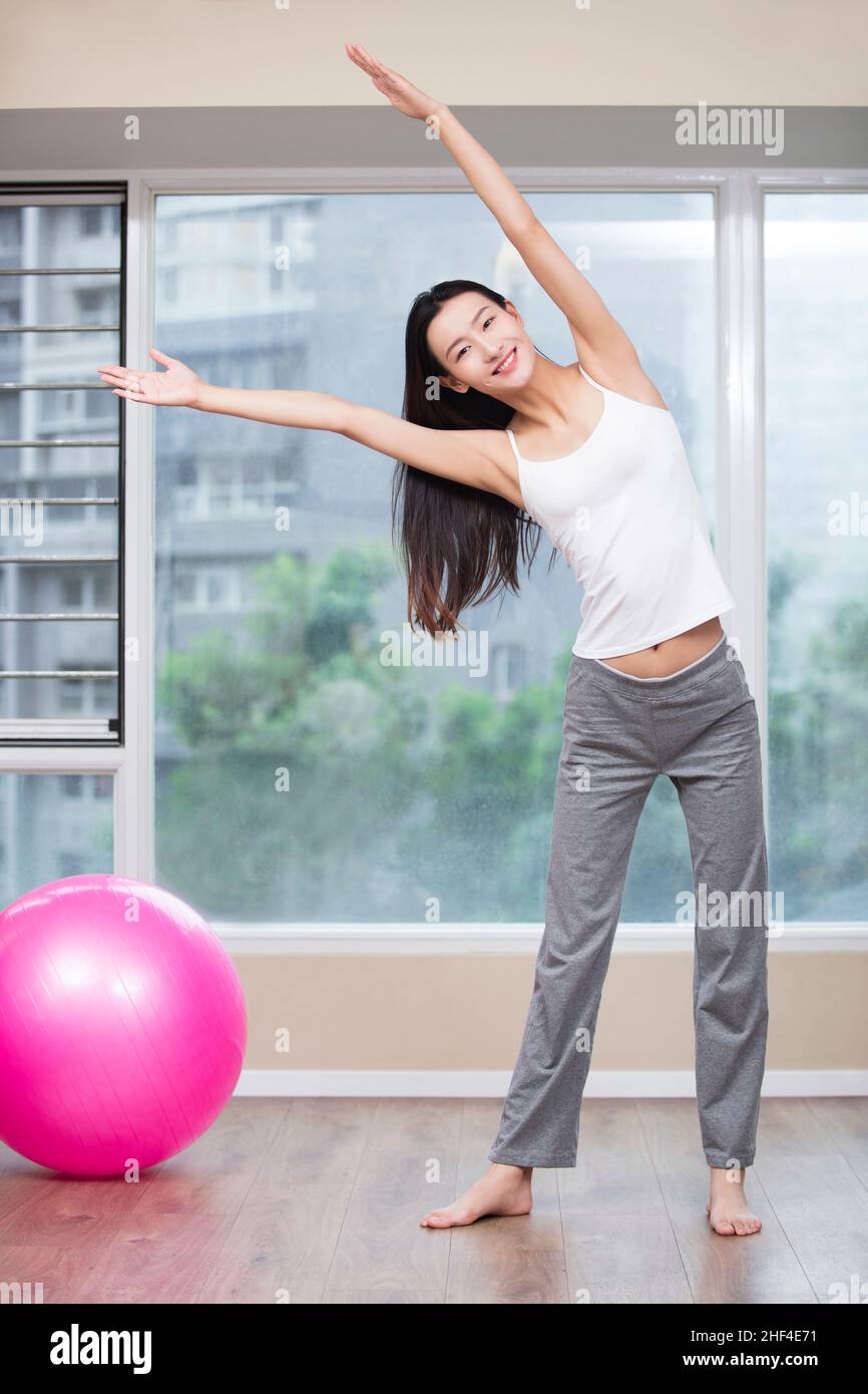 Young woman practicing yoga at home Stock Photo