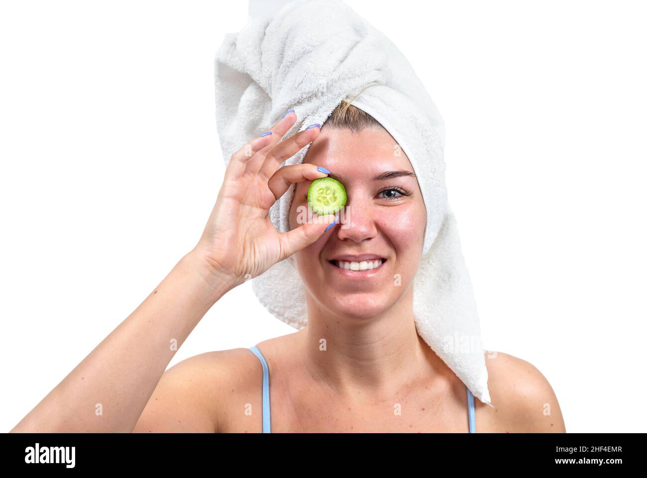 Young woman with cucumber and towel isolated on white background Stock Photo