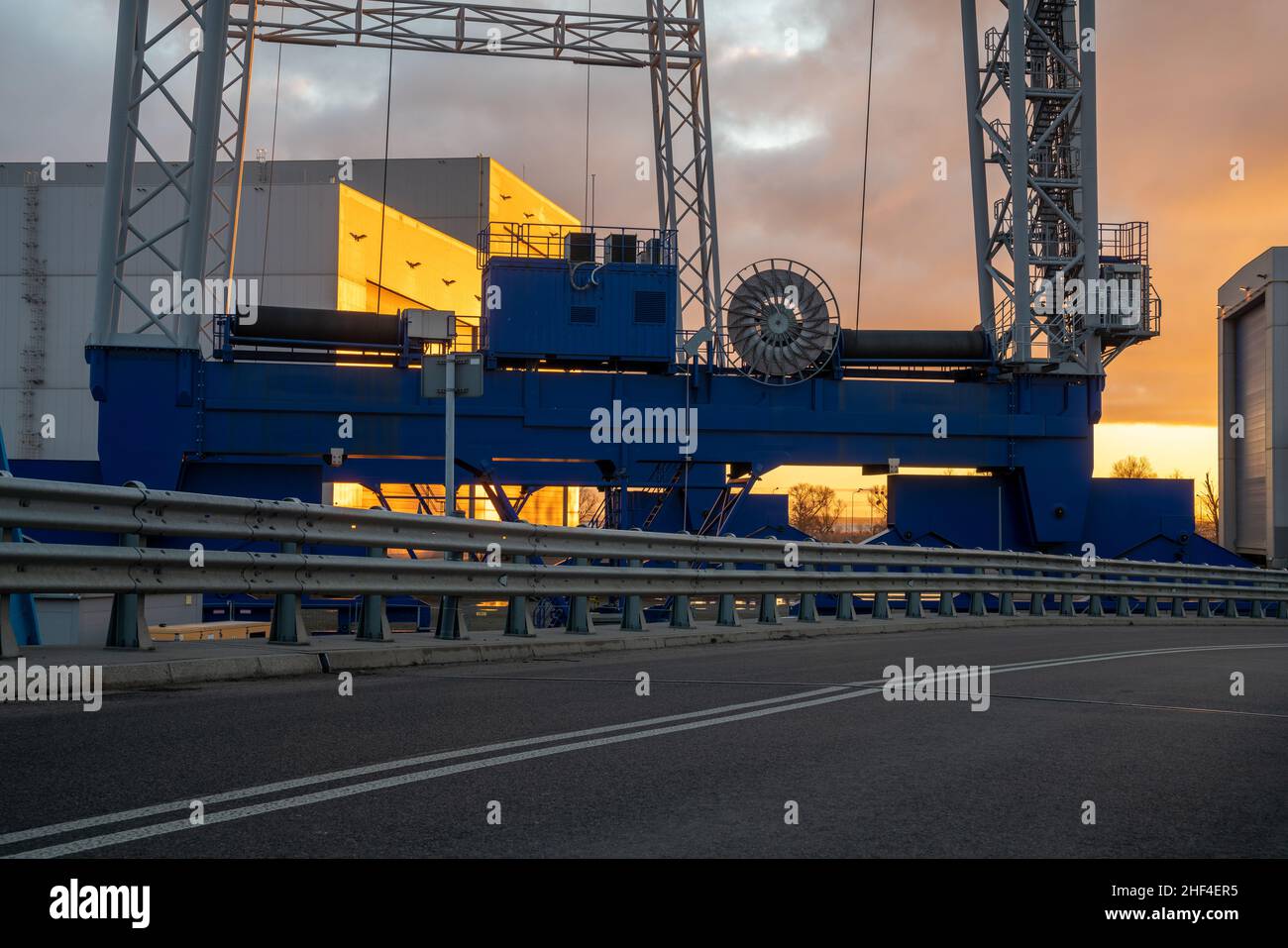 Asphalt road leading through an industrial area,image perfect as a background for 3d rendering Stock Photo