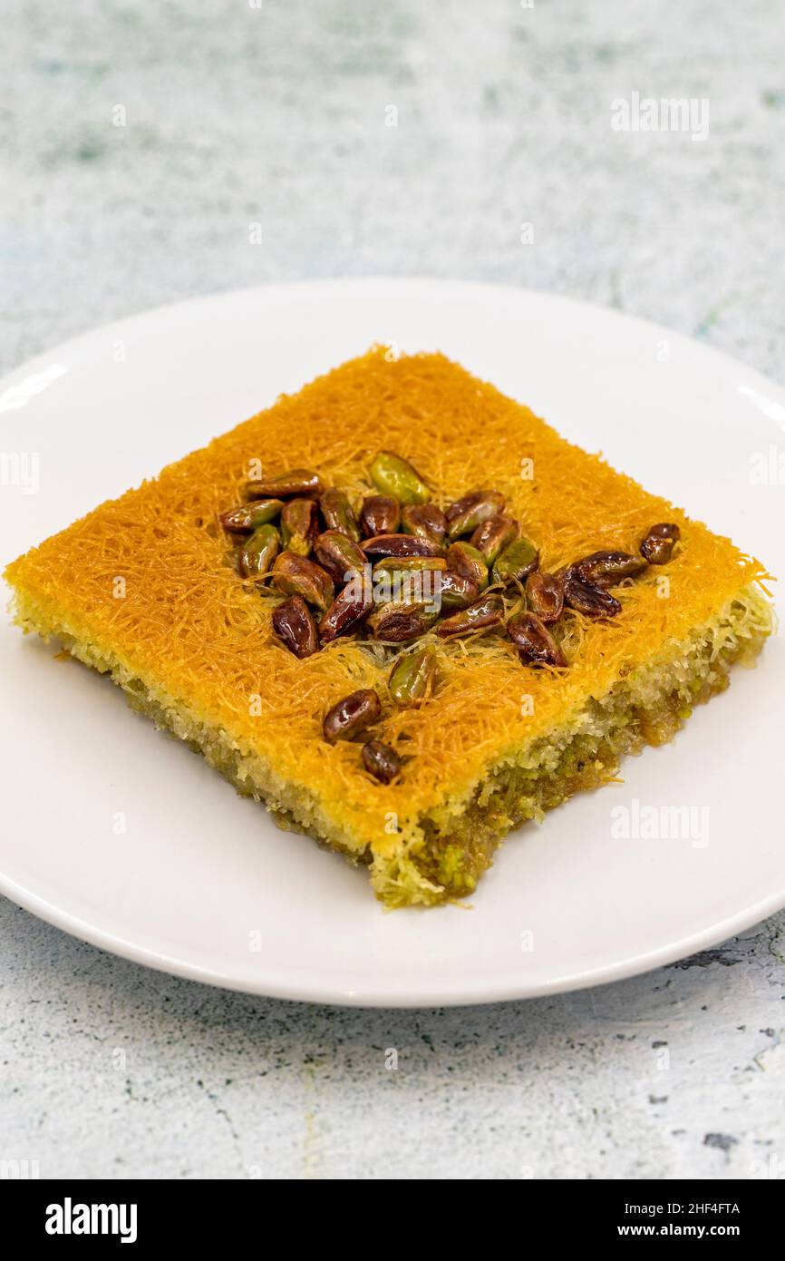 Pistachio kadayif dessert on stone background. Traditional Turkish ...