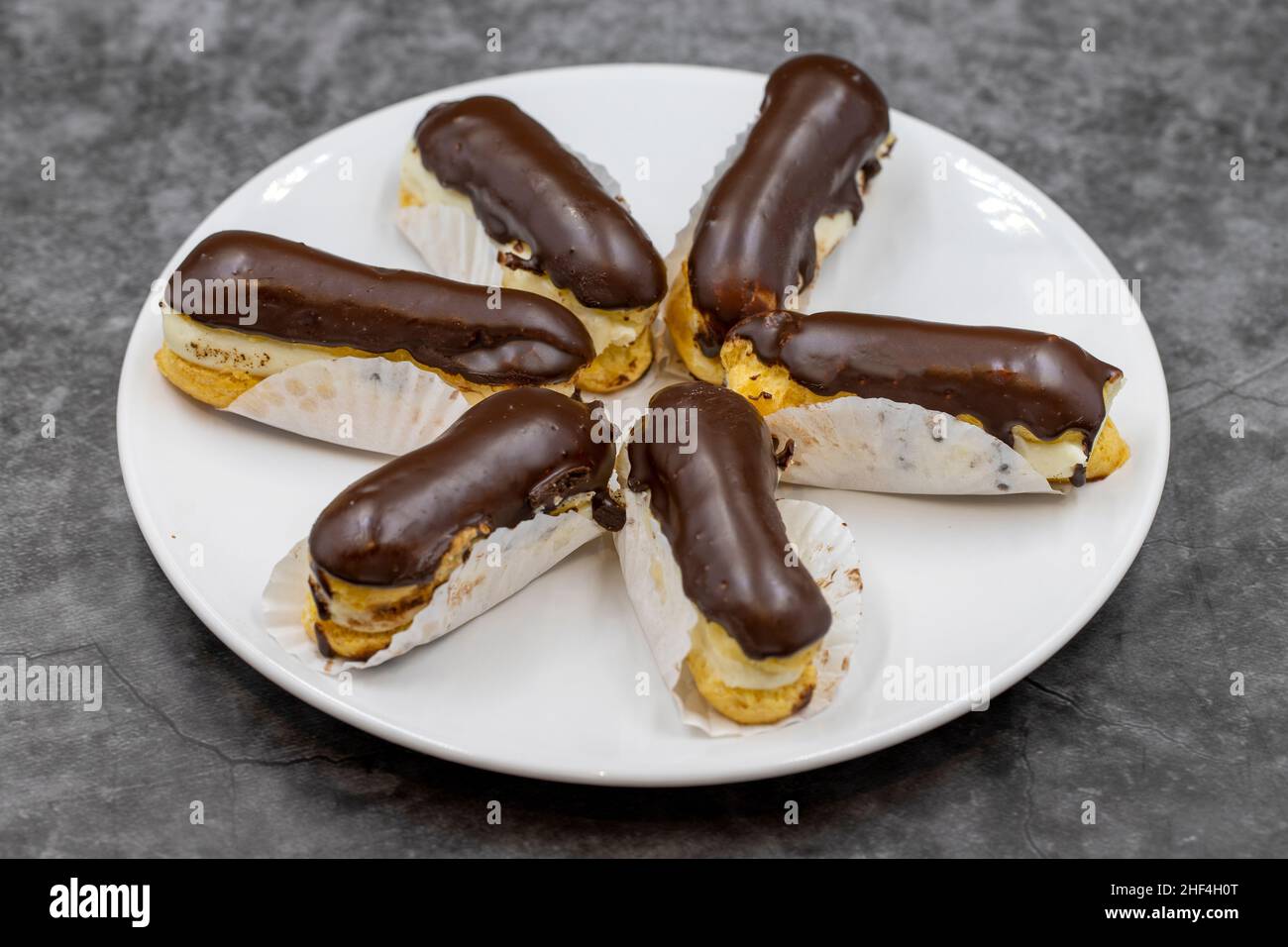 Chocolate eclair cake on dark background. Traditional french dessert ...