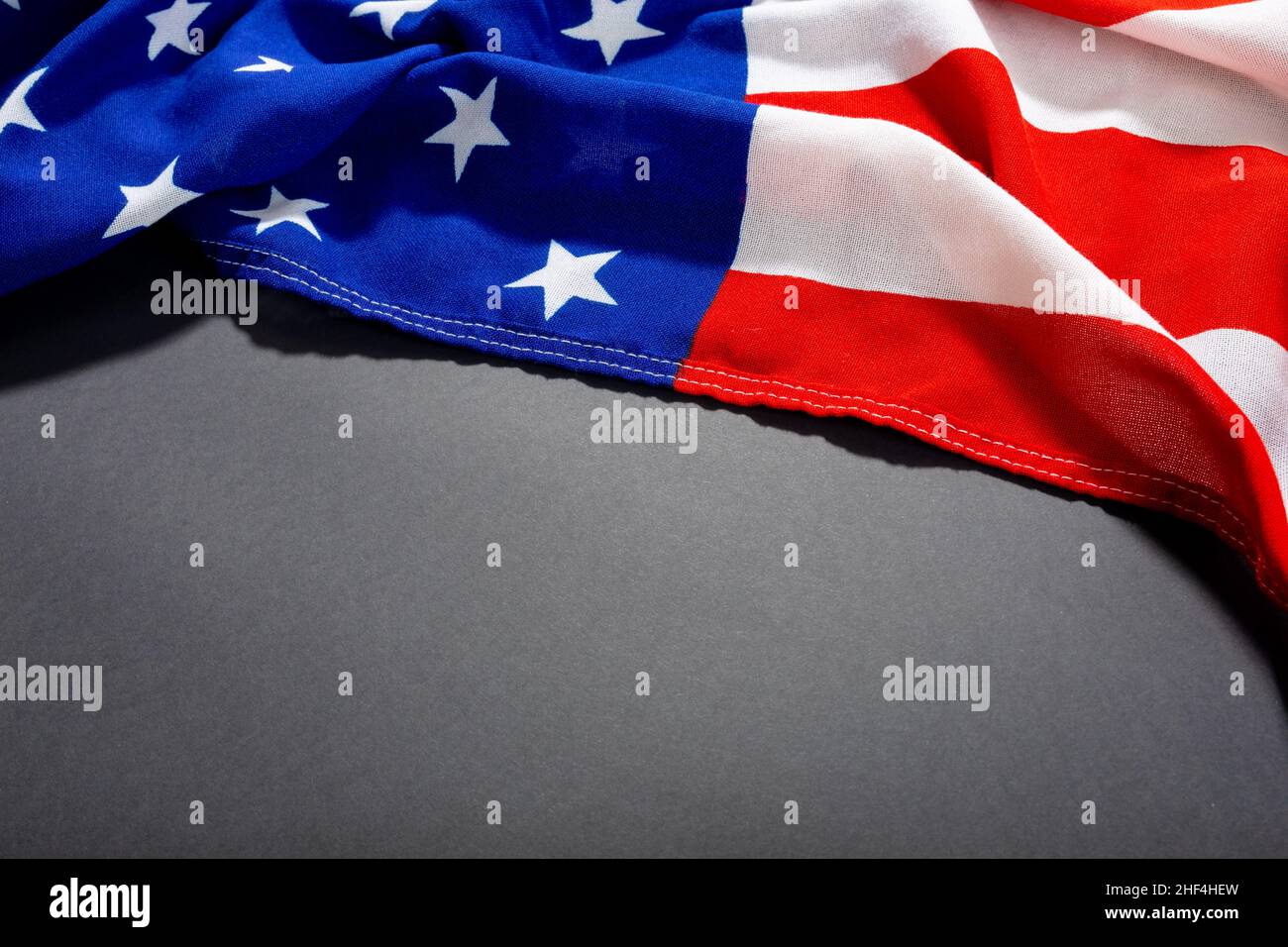 High angle shot of america flag with stars and stripes pattern on black table and copy space Stock Photo