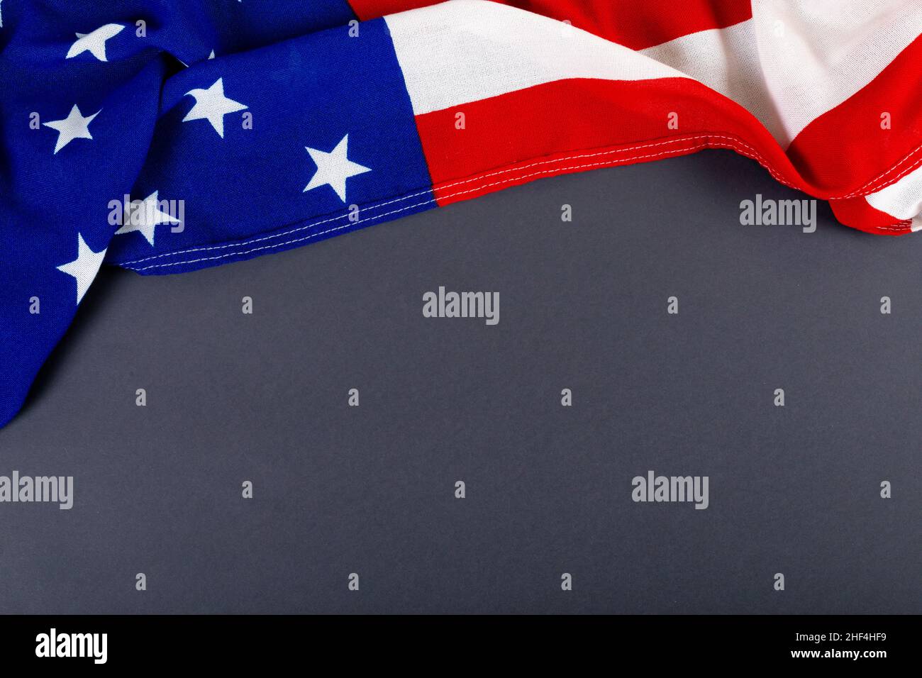 High angle view of america flag with stars and stripes pattern on black table with copy space Stock Photo