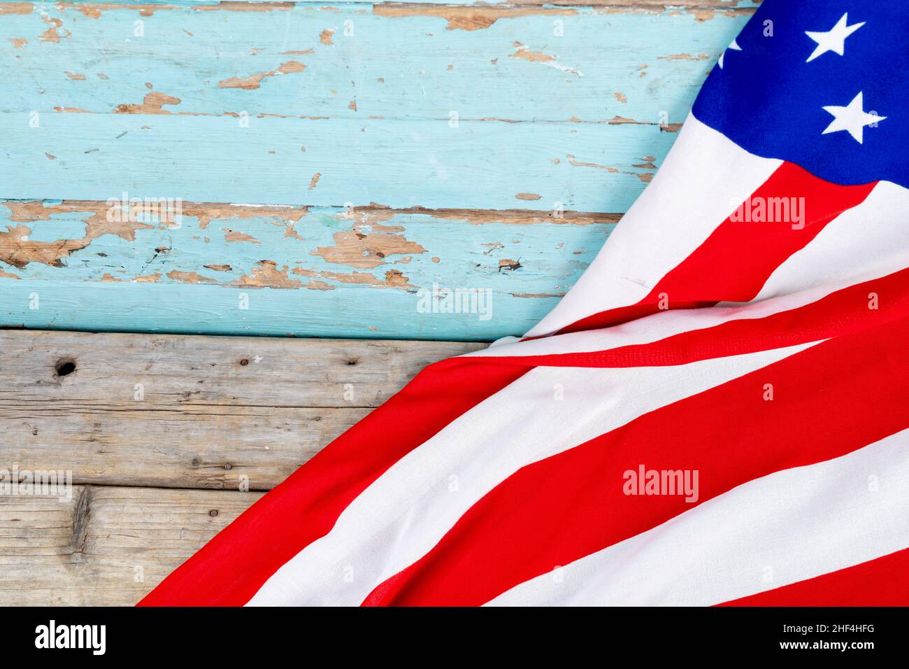 Red and white stripes with stars on usa flag over blue wooden table ...