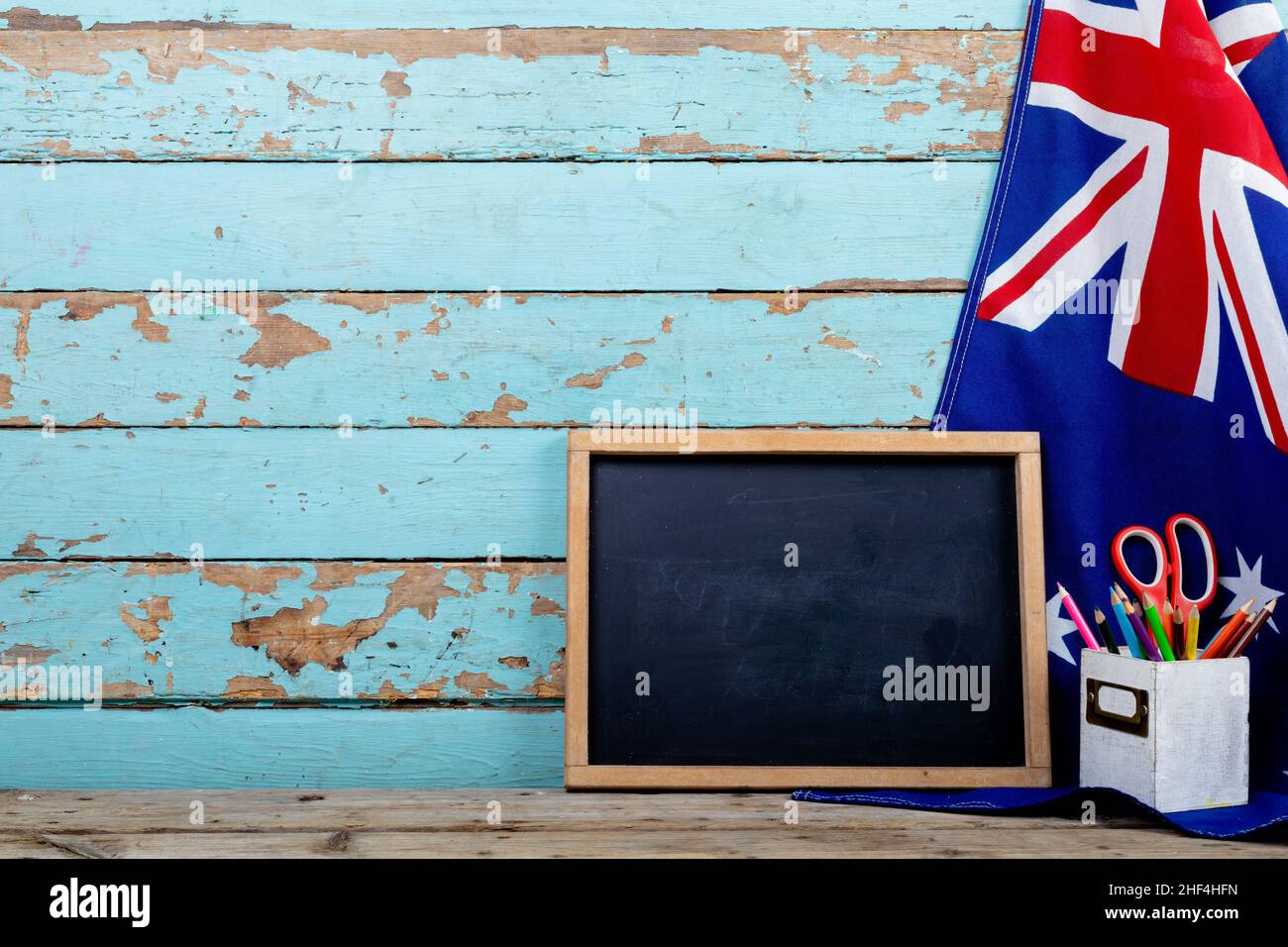 Blank writing slate with copy space by desk organizer on australia flag over table Stock Photo