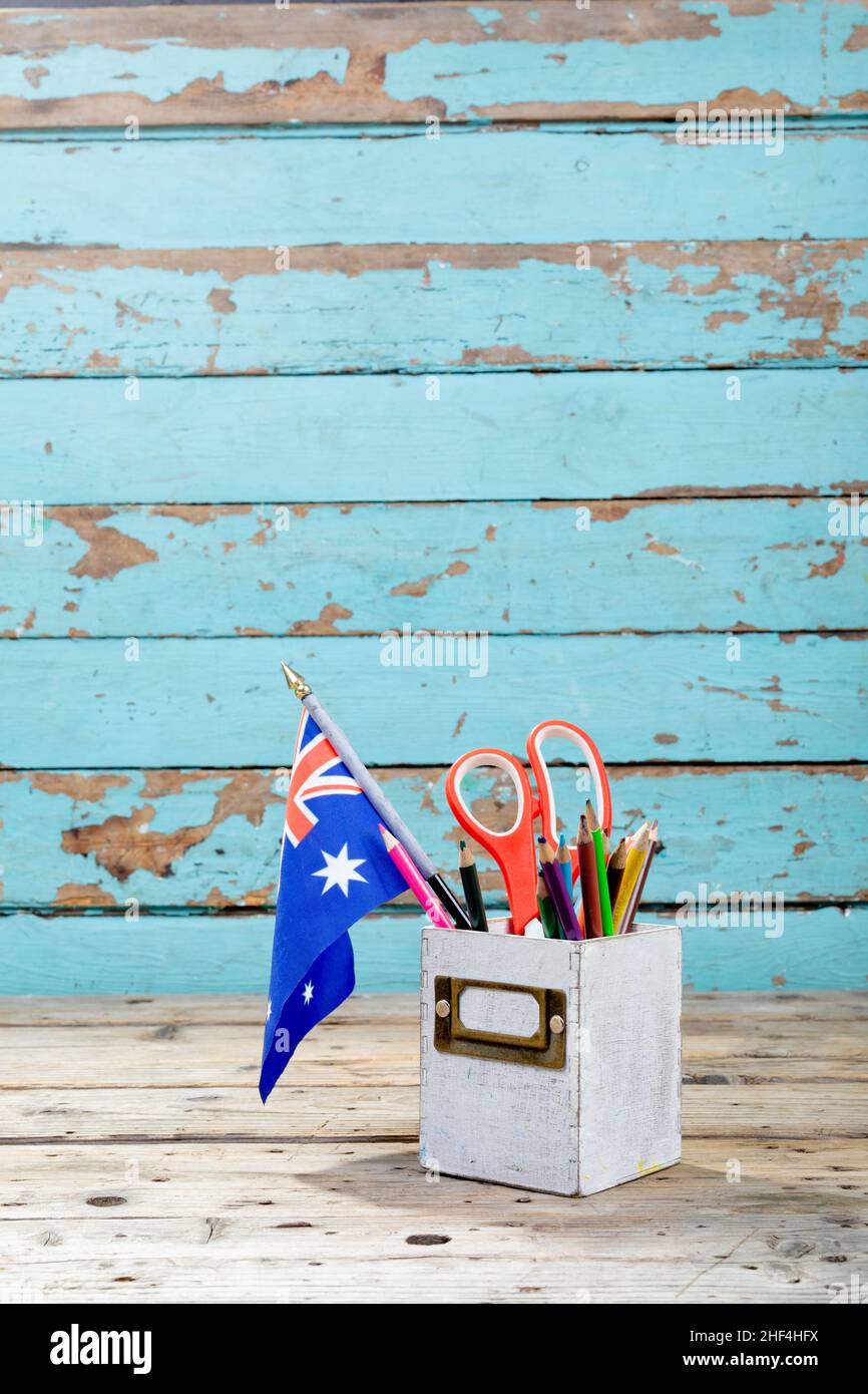 Desk organizer with office supply and australia flag on table against wooden wall Stock Photo