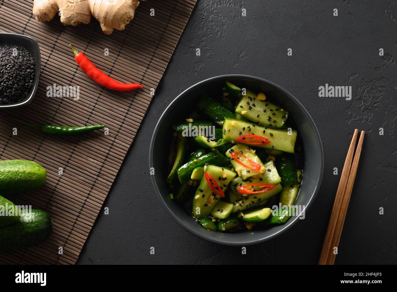 Asian spicy broken Cucumber salad with coriander leaves, ginger, pepper
