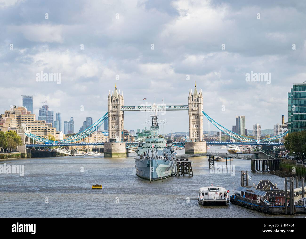 HMS Belfast with Tower Bridge and the river Thames, London, UK Stock Photo