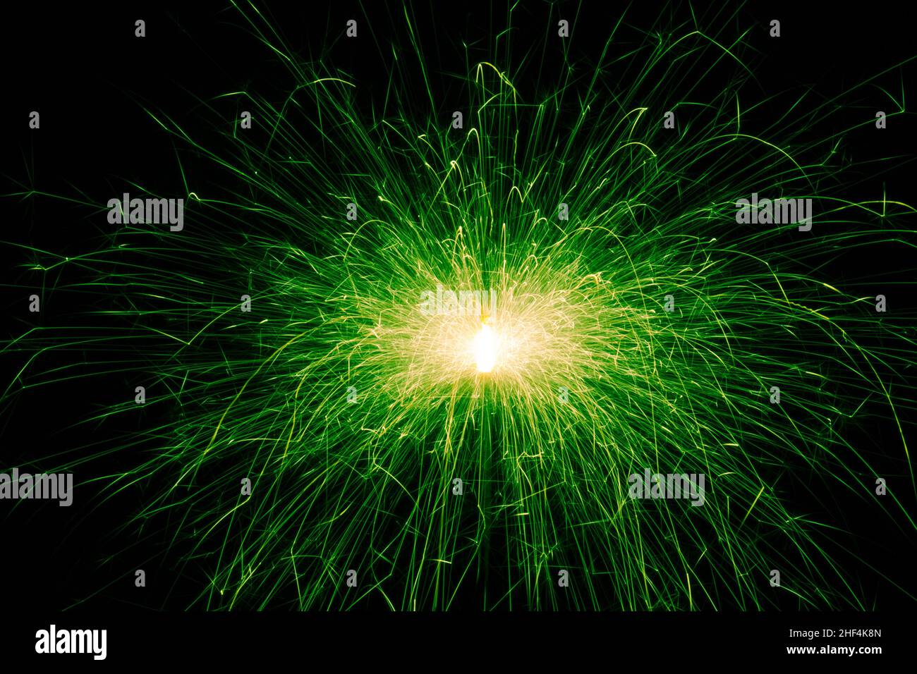 Sparkler, green sparks on a black background. Abstract photo of sparks, holiday lights Stock Photo
