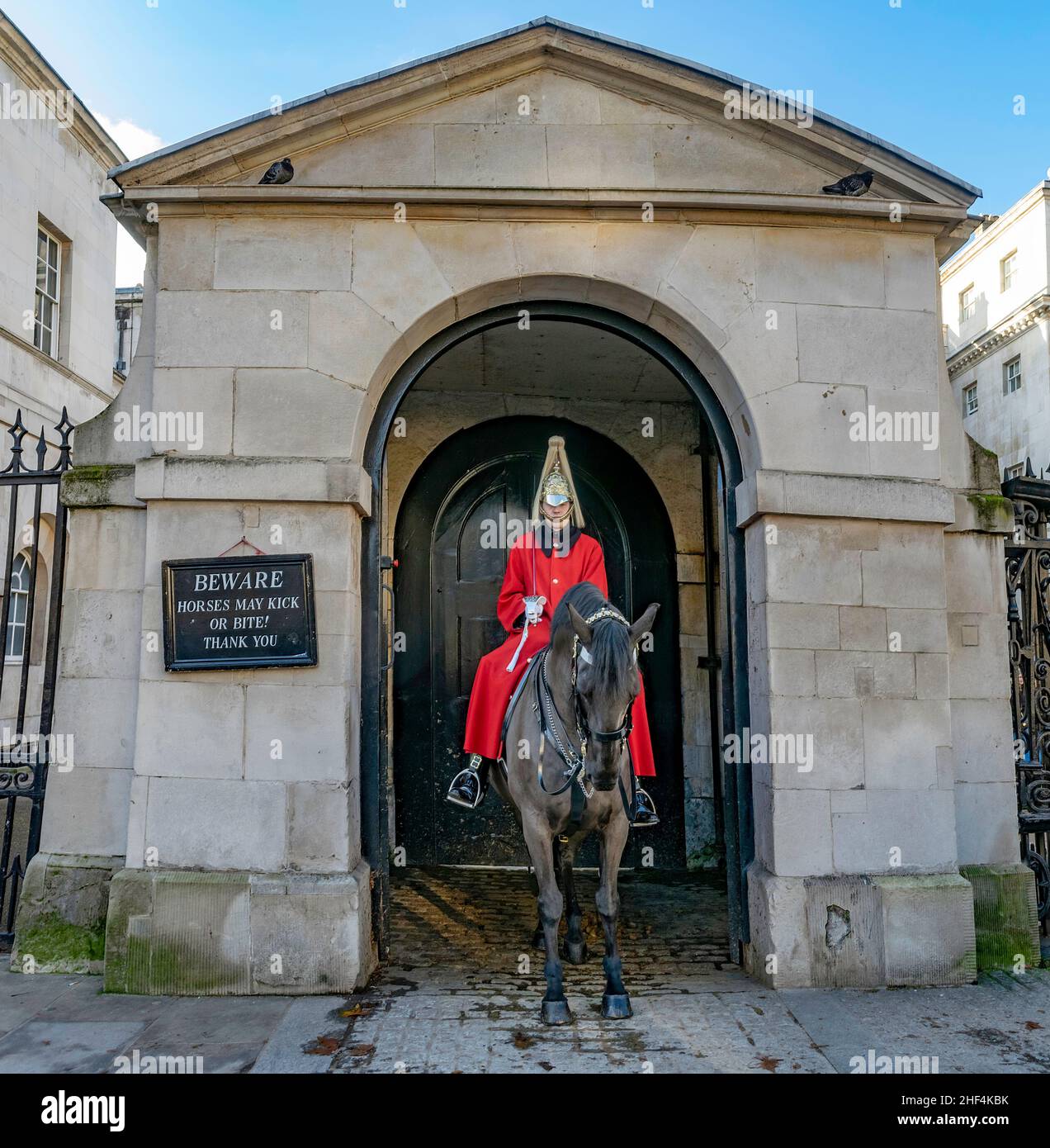 Cavalryman guard on horse at Royal Horse Guards Gate with the famous Beware Horses May Bite sign. London, England Stock Photo