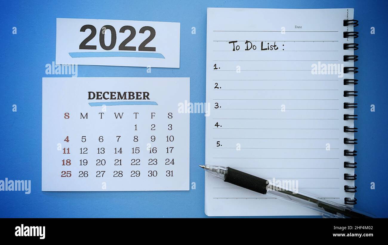 To do list text written on notepad with pen and December calendar 2022 background. 2022 new year concept. Stock Photo