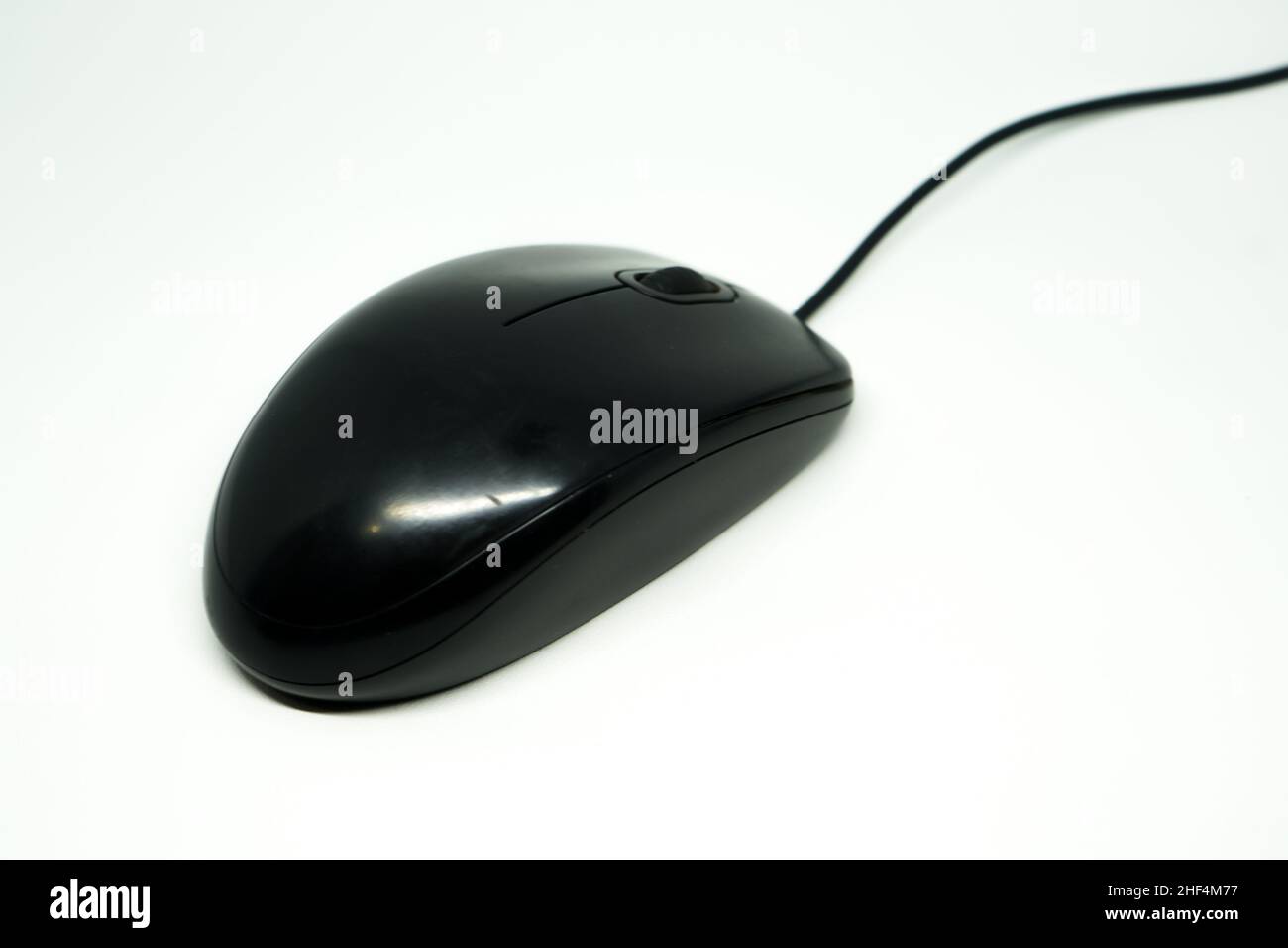 Black computer mouse uses a wired connection and uses an infrared