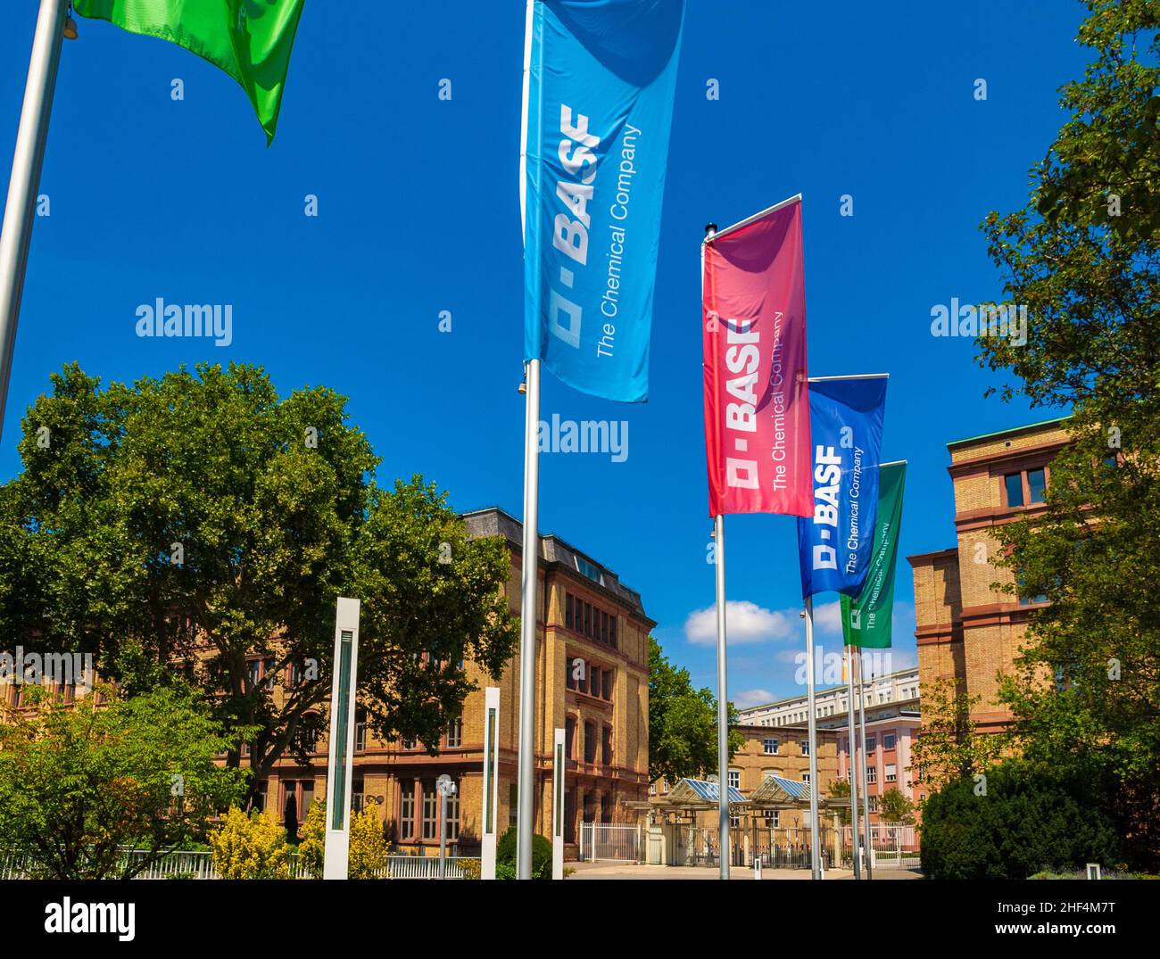 Great view of the entrance gate with a row of colourful BASF flags at the headquarter of the world's largest chemical producer BASF in Ludwigshafen am... Stock Photo