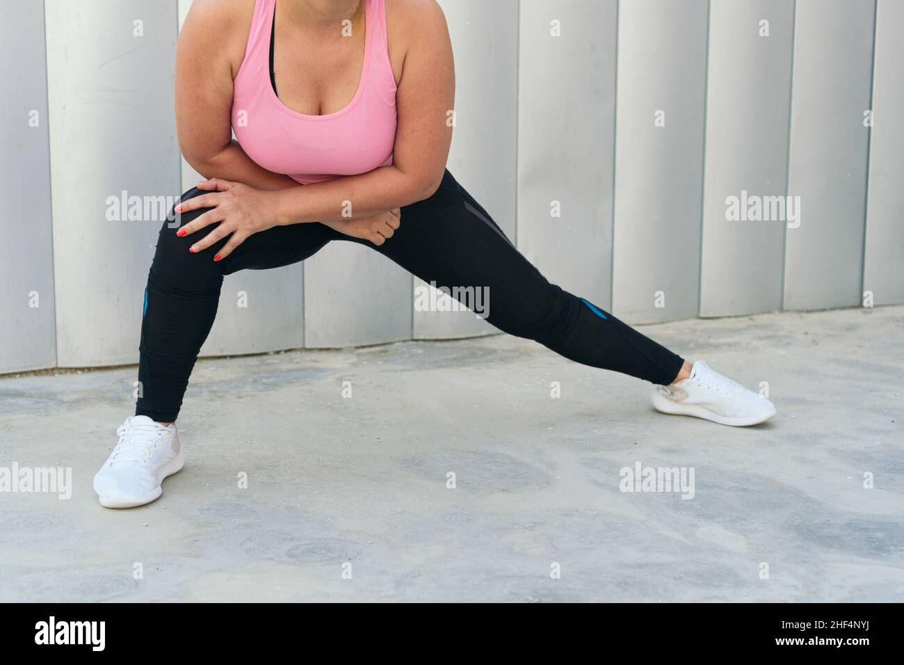 Athletic Woman Stretching Legs During Workout Stock Photo - Alamy