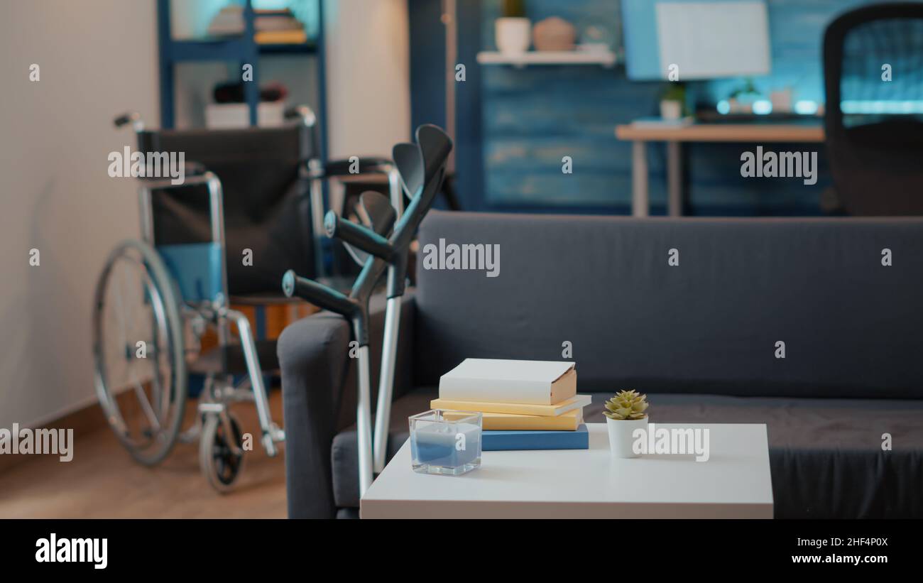 Nobody in living room with walking support equipment. Wheelchair and