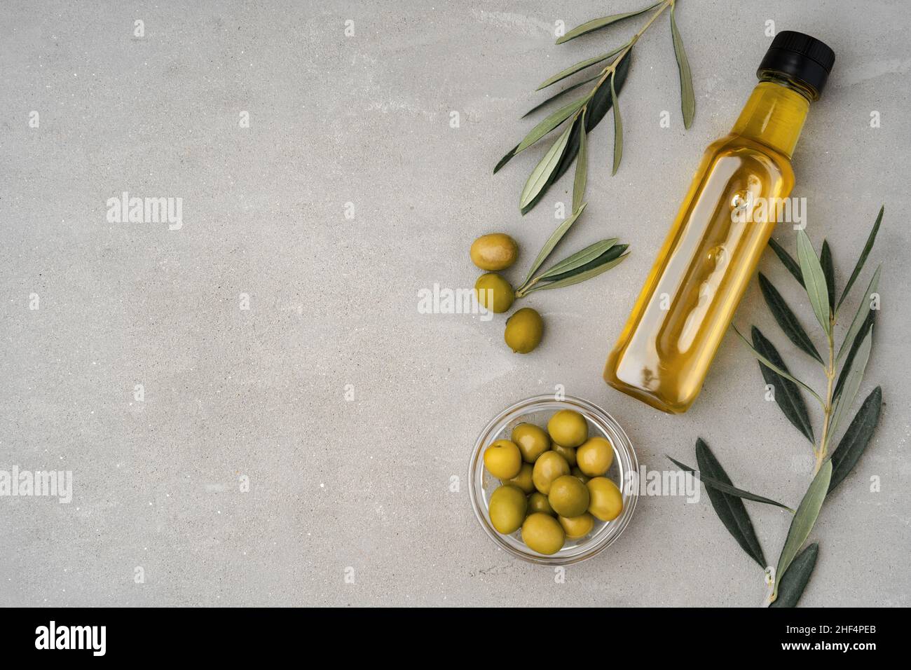 Glass bottle with olive oil on gray background Stock Photo - Alamy