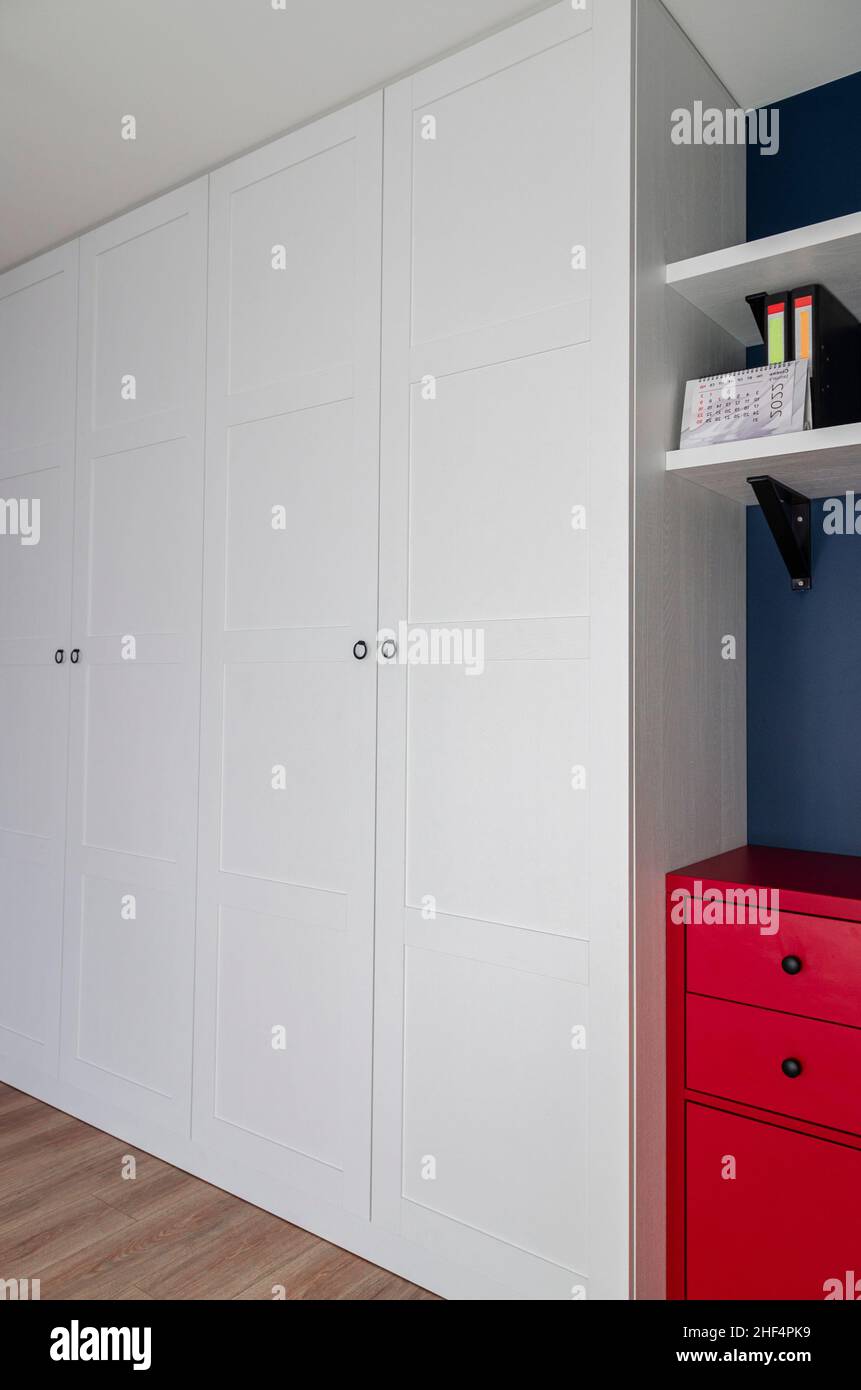 View of The interior of the apartment in the Scandinavian style. White wardrobe ...