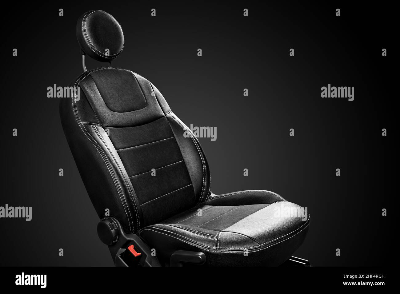 Ergonomic driver car seat with round headrest isolated on black