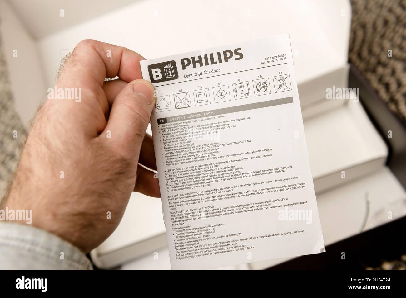 Paris, France - Nov 29, 2021: POV male hand reading manual after unboxing  unpacking new Philips Signify HUE white and color ambiance lightstrip  outdoor 5 meter smart Stock Photo - Alamy