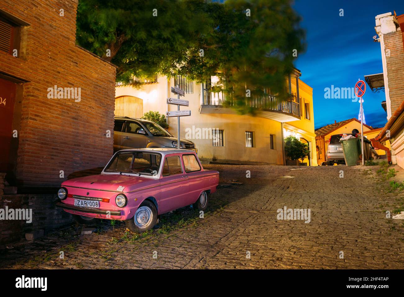 Parked Rarity Tuning Pink Minicar Zaporozhets On Paved Street In Old District Of Tbilisi, Georgia Stock Photo