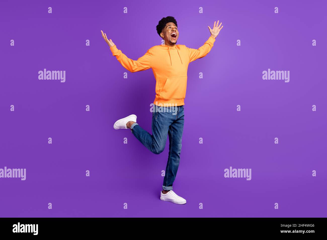 Full size photo of cheerful dark skin amazed man look empty space ...