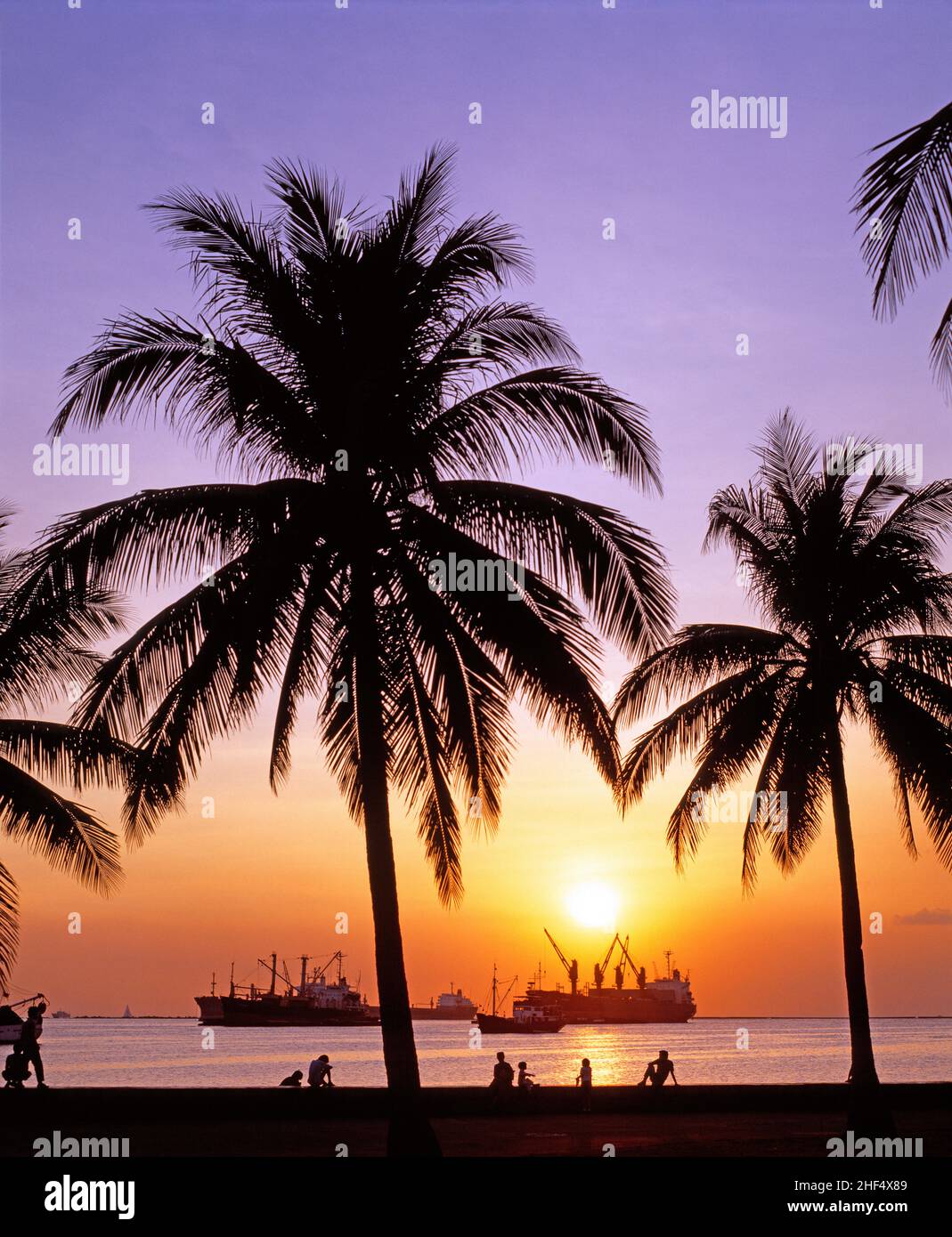 Philippines. Manila. Sunset over Manila Bay with commercial ships. Stock Photo
