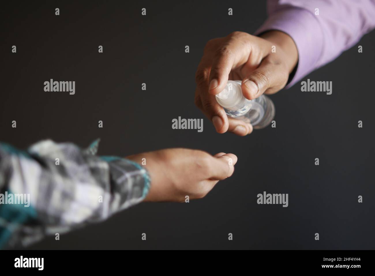 two people using sanitizer gel for preventing virus. Stock Photo