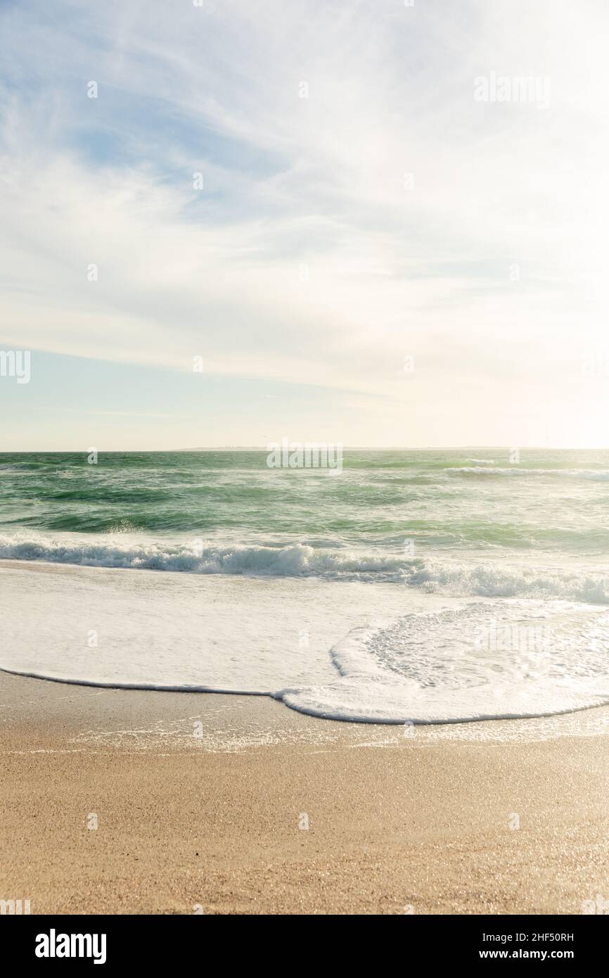 Scenic view of horizon on sea against sky with clouds on sunny day Stock Photo